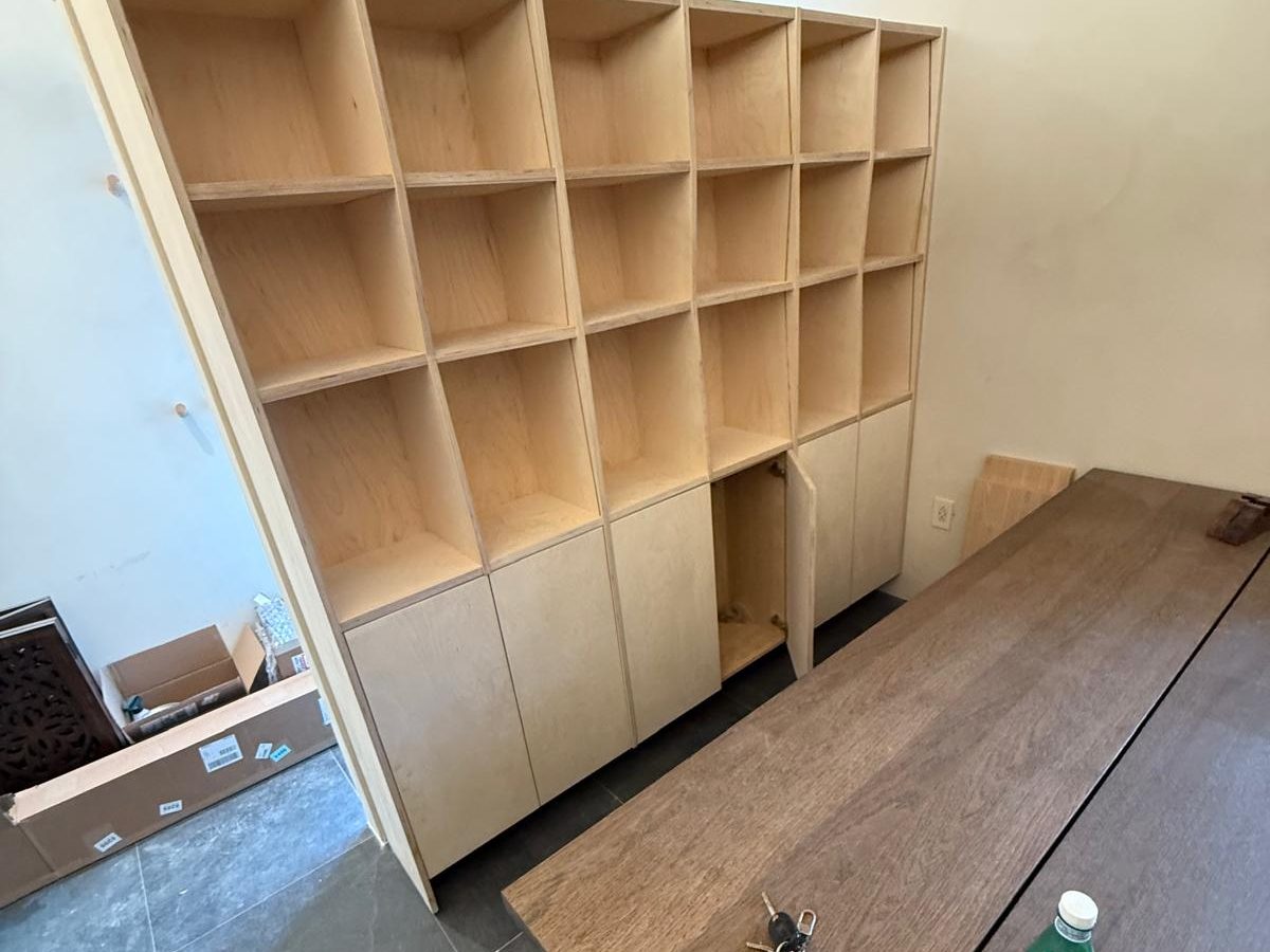 Floor-to-ceiling birch bookcase with cubbies above and doors below