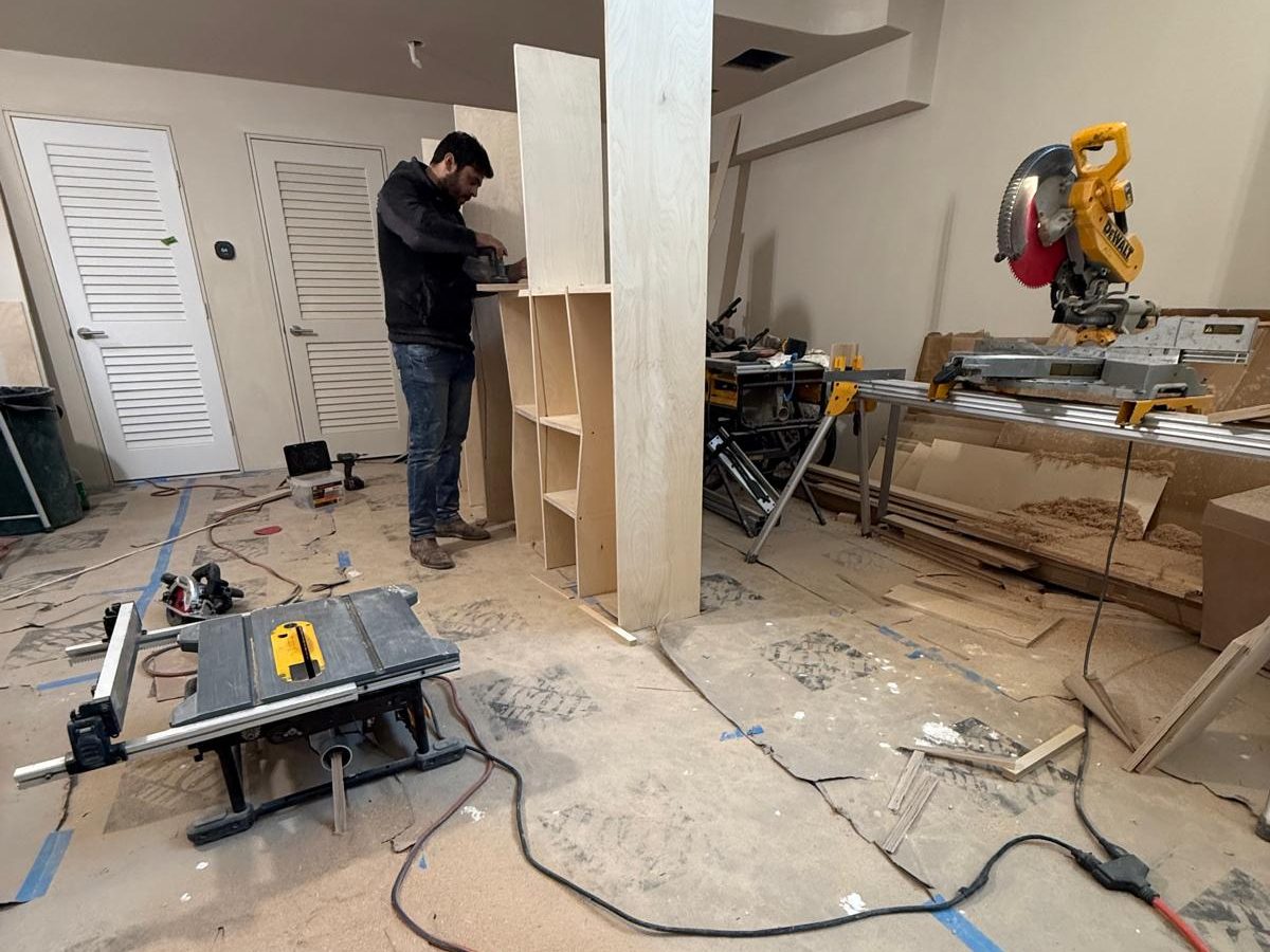 Sanding bookcase parts on site between the miter saw and table saw