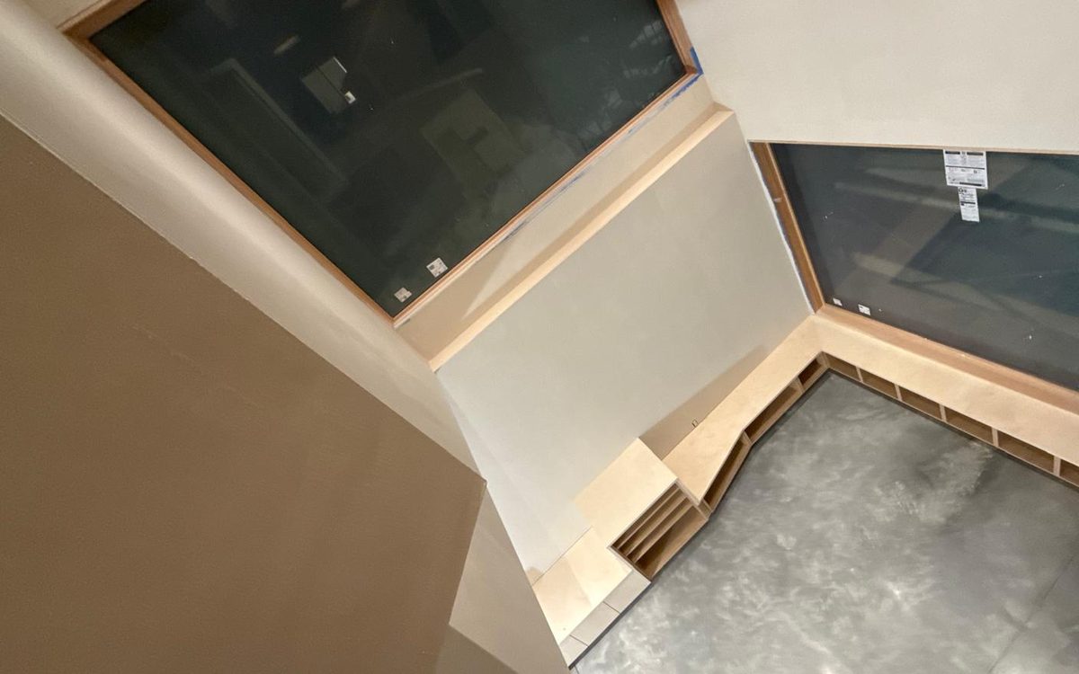 Basement built-ins and window seat seen from the stair landing