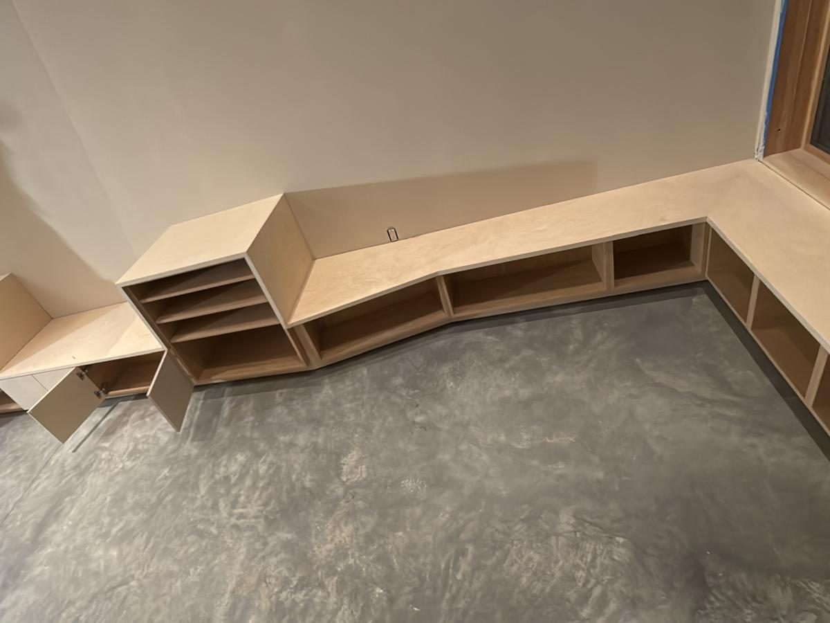 Angled run of built-in shelving following the basement wall