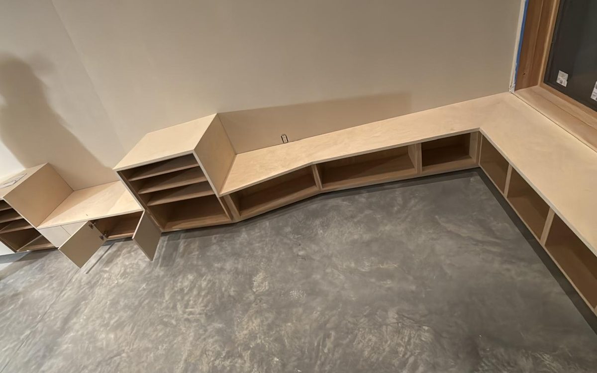Angled run of built-in shelving following the basement wall