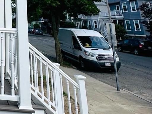 Porch stairs with white railings leading down to the sidewalk
