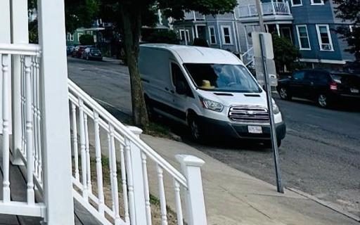 Porch stairs with white railings leading down to the sidewalk