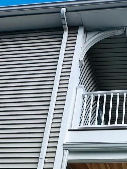 Vinyl lap siding, gutter and decorative eave bracket on the porch corner