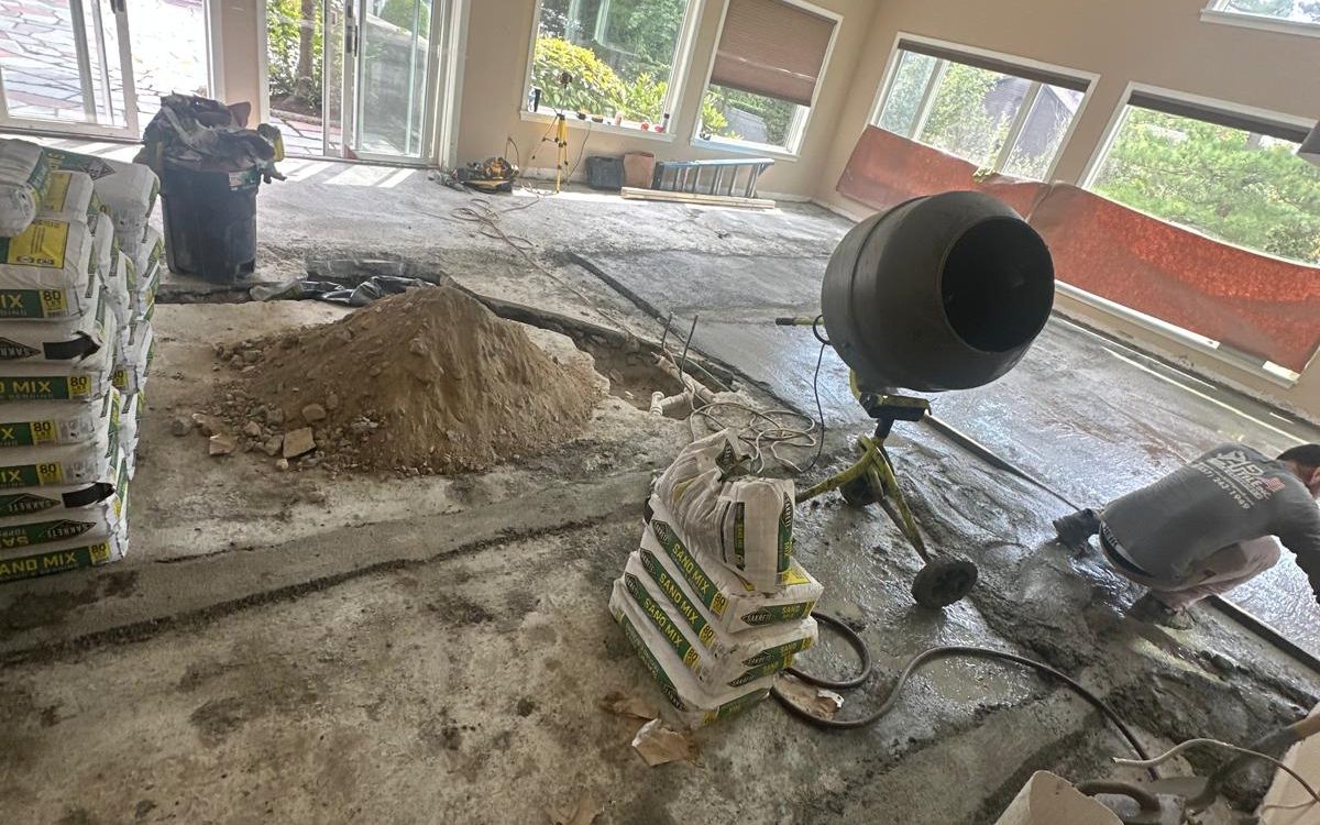 Mixing mortar to rebuild the floor after new plumbing was run