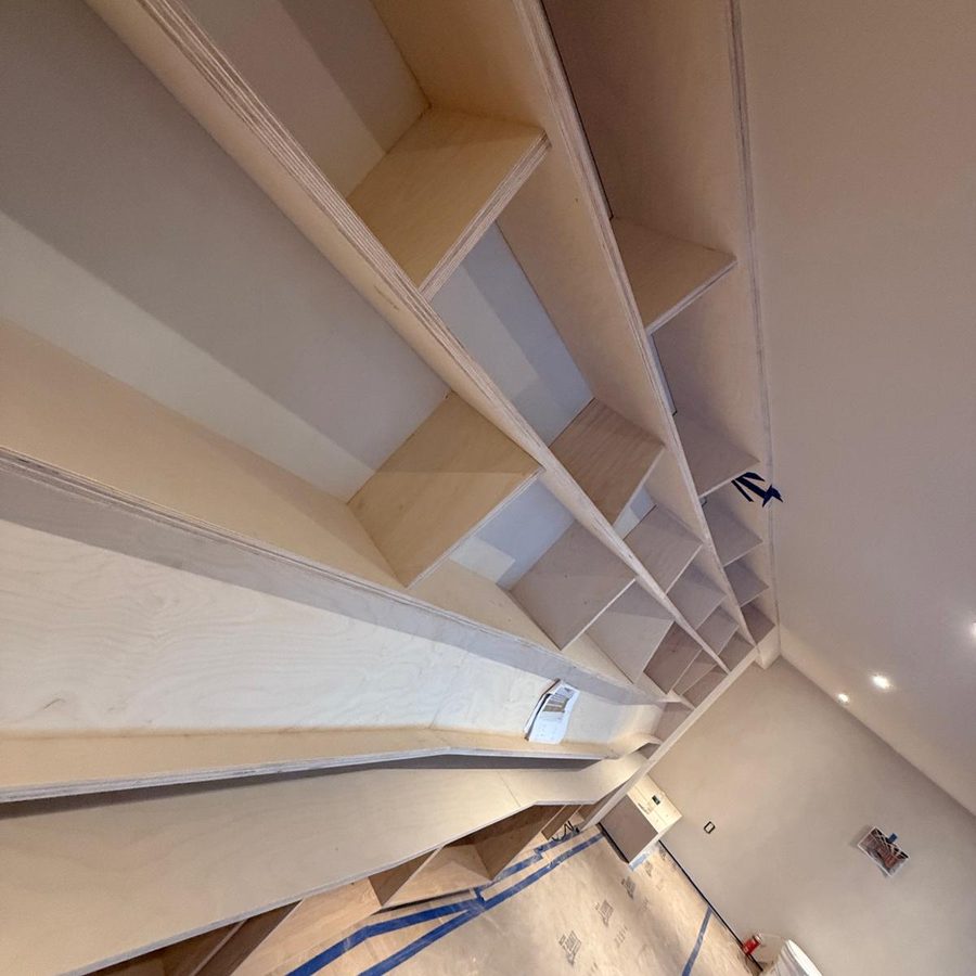 Angled shelf dividers of the built-in library seen from below