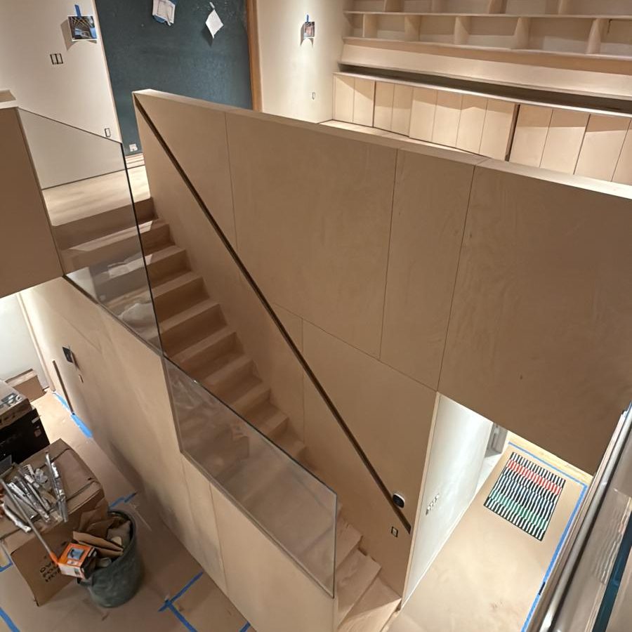 Stair enclosed in birch plywood and glass, seen from above