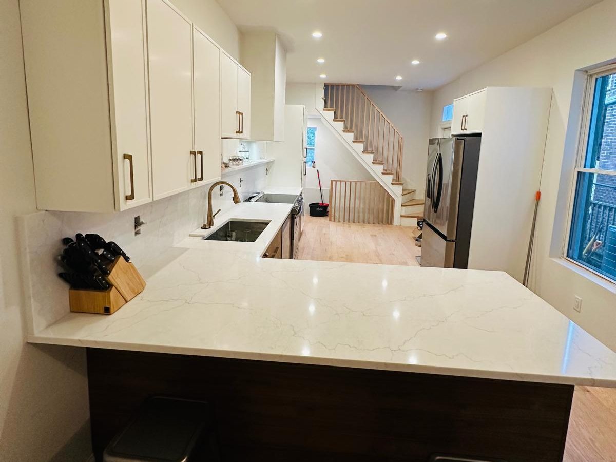 Quartz peninsula with seating and the new oak staircase in the background