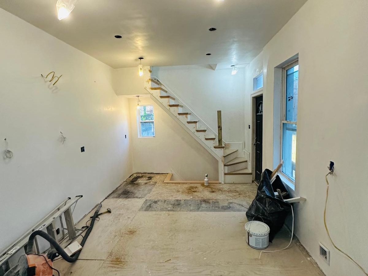 Freshly painted open floor plan with the new stair at the back