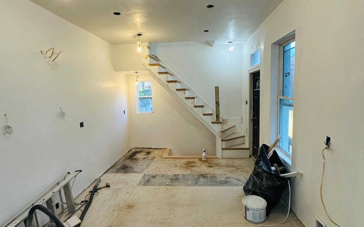 Freshly painted open floor plan with the new stair at the back