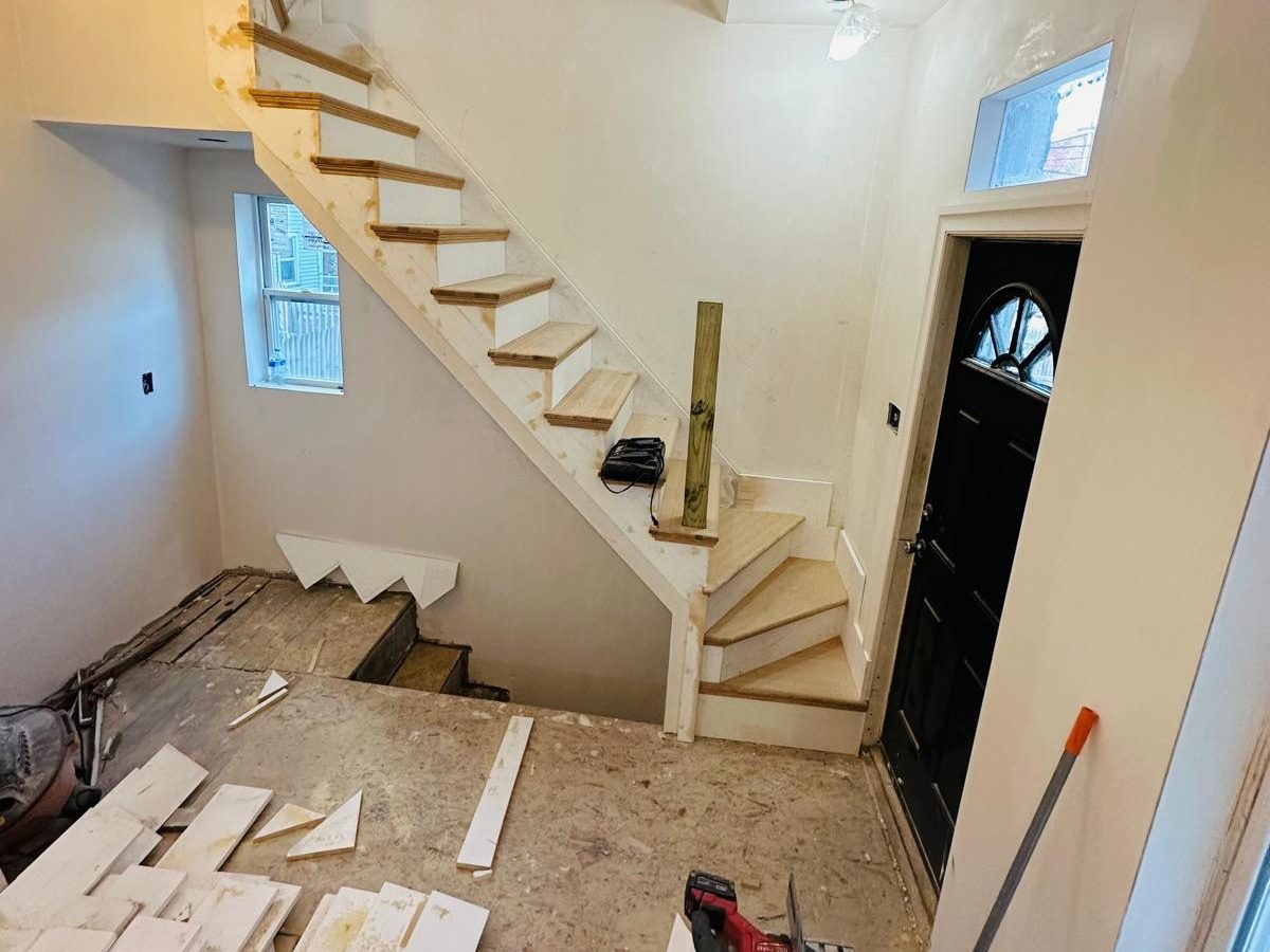 New stair with oak treads built beside the front entry door