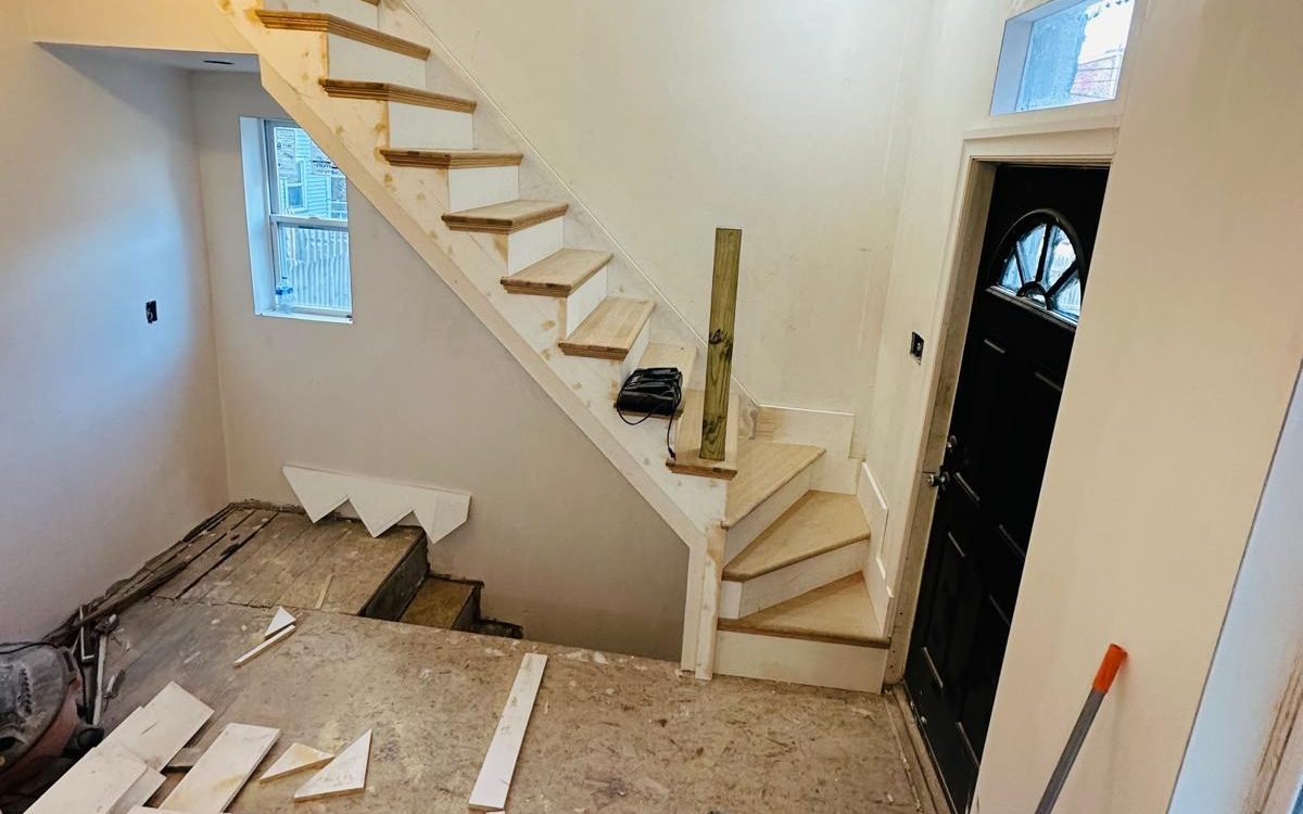 New stair with oak treads built beside the front entry door